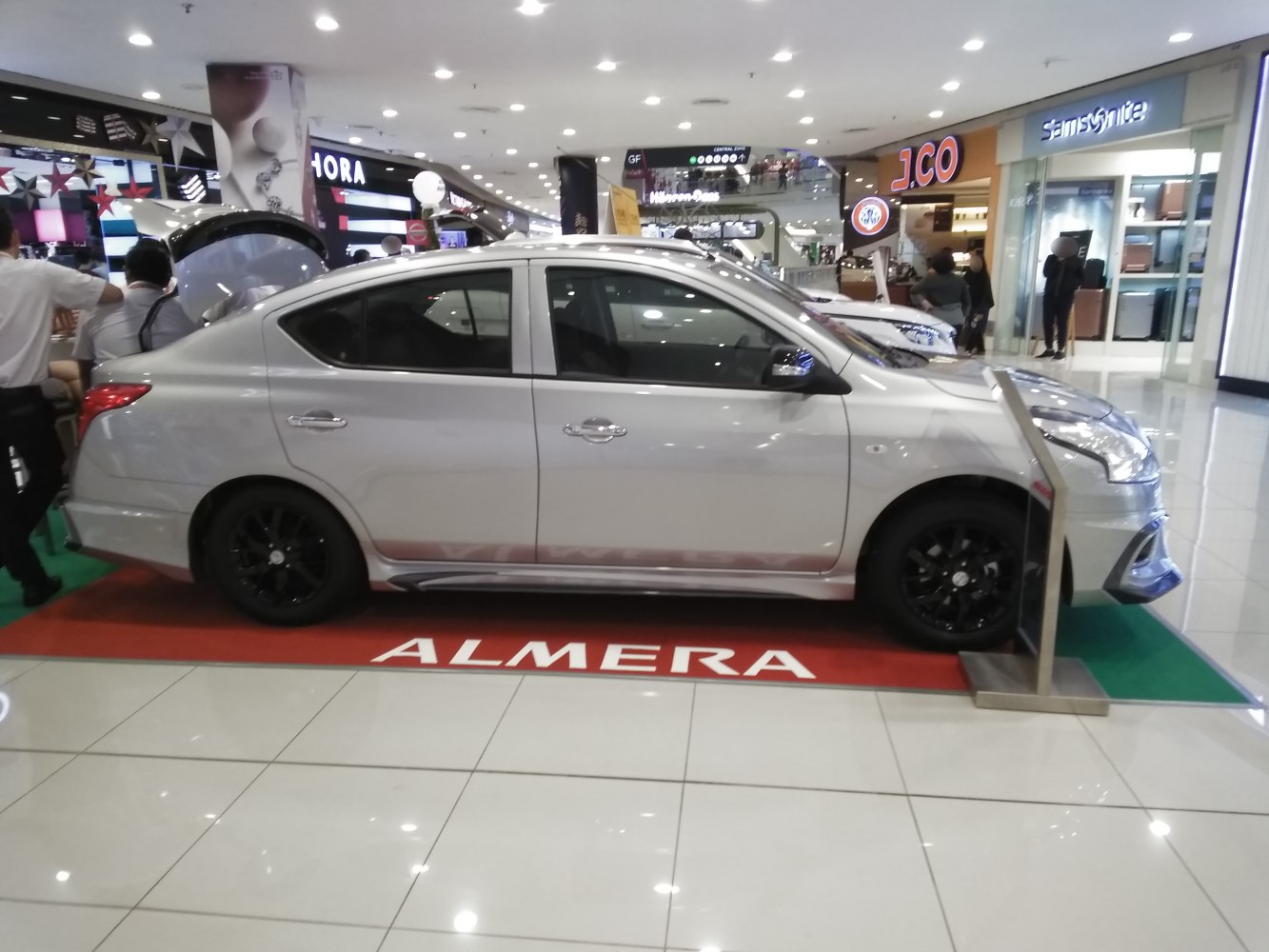 Side profile view with black alloy wheels and tinted windows
