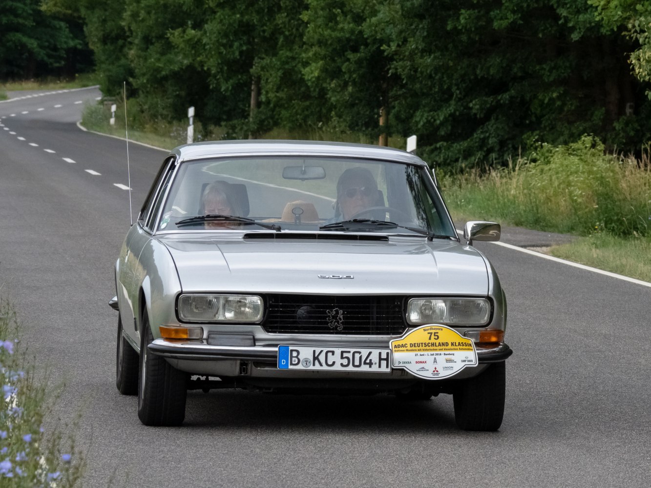 Front view of vintage coupe with rectangular headlights and horizontal grille