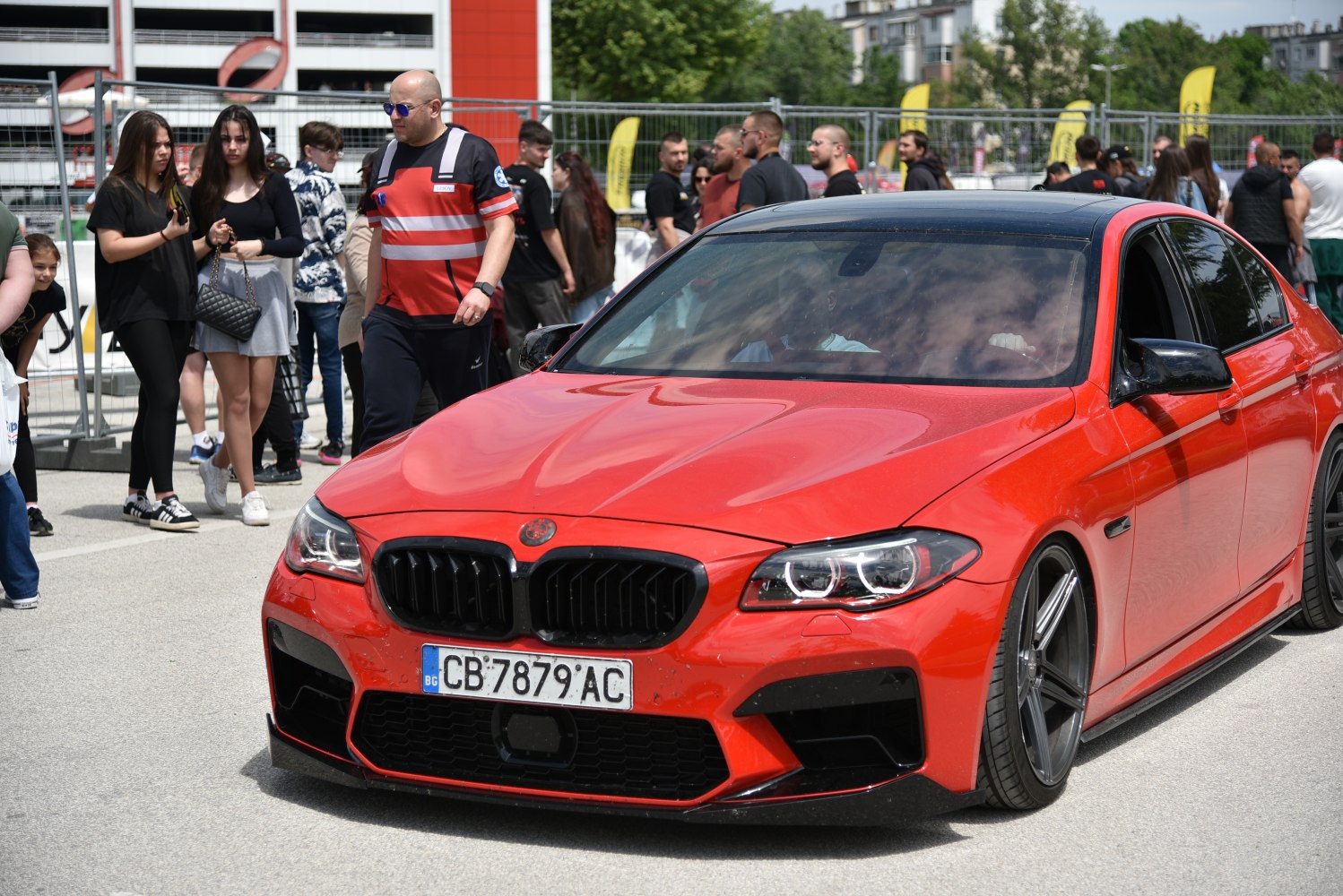 Red sedan front with LED headlights and black kidney grille