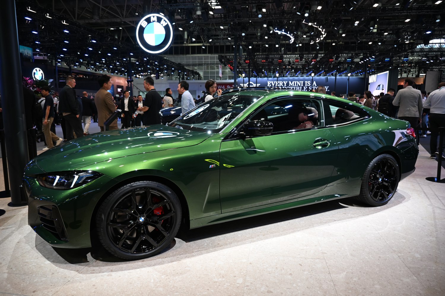 Sleek metallic green coupe with black alloy wheels