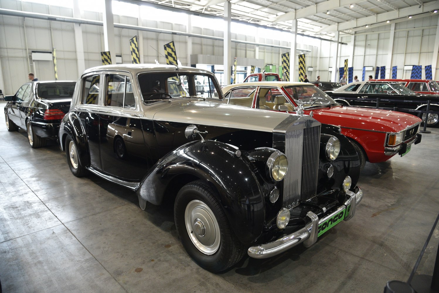 Vintage luxury sedan front with chrome grille and round headlights