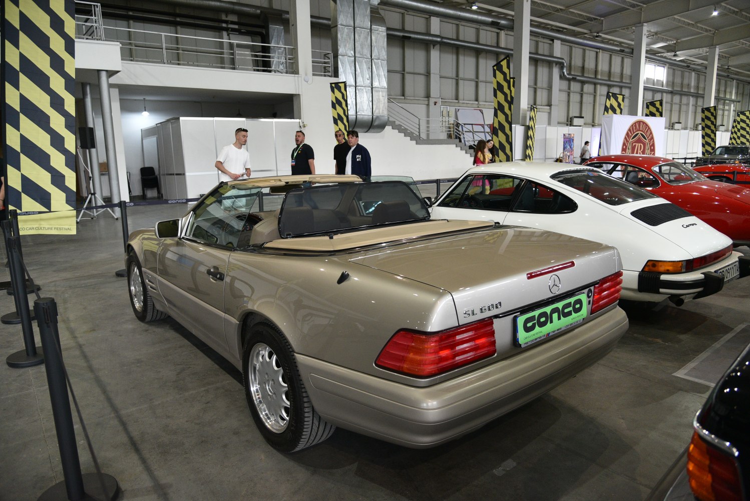 Rear and side view of beige convertible with prominent tail lights and smooth body lines