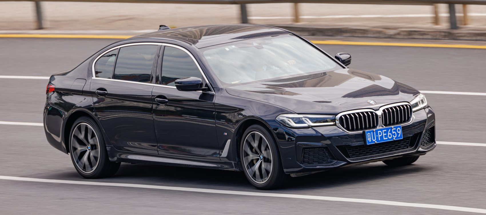 Sleek front side view with kidney grille and sporty wheels
