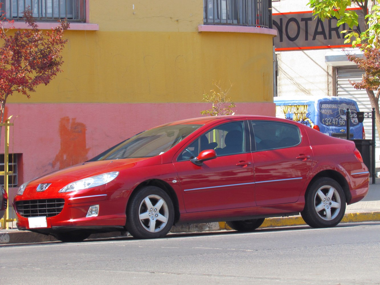 Red mid-size 2009 sedan with distinct front grille and sleek side view