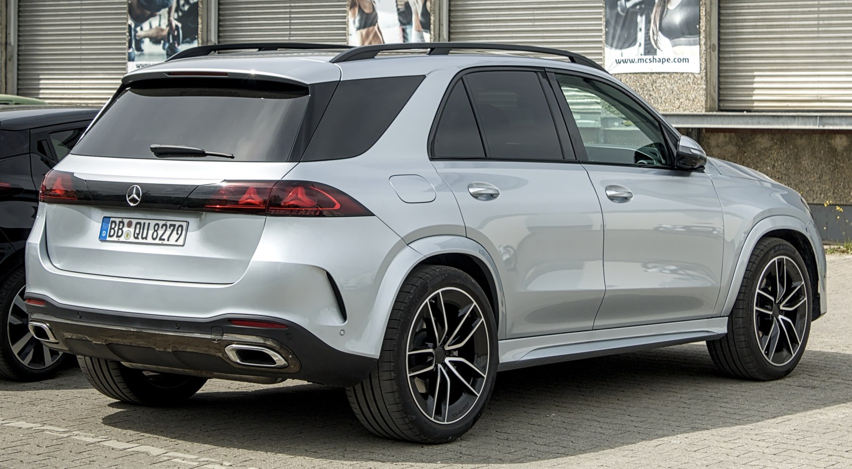 Rear and side view of an SUV with sleek taillights and dual exhaust