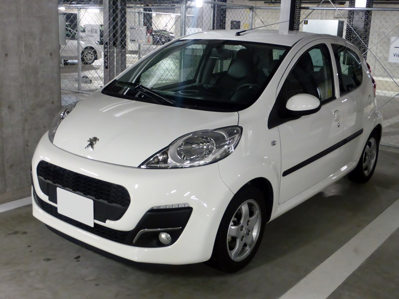 Compact 5-door hatchback with large headlights and prominent grille