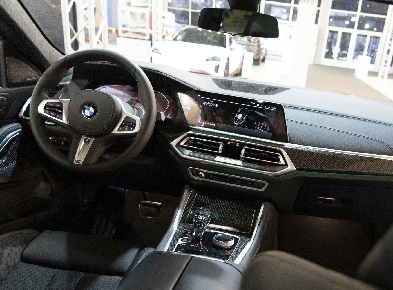 Modern 2020 BMW X6 interior with digital dashboard and steering wheel controls