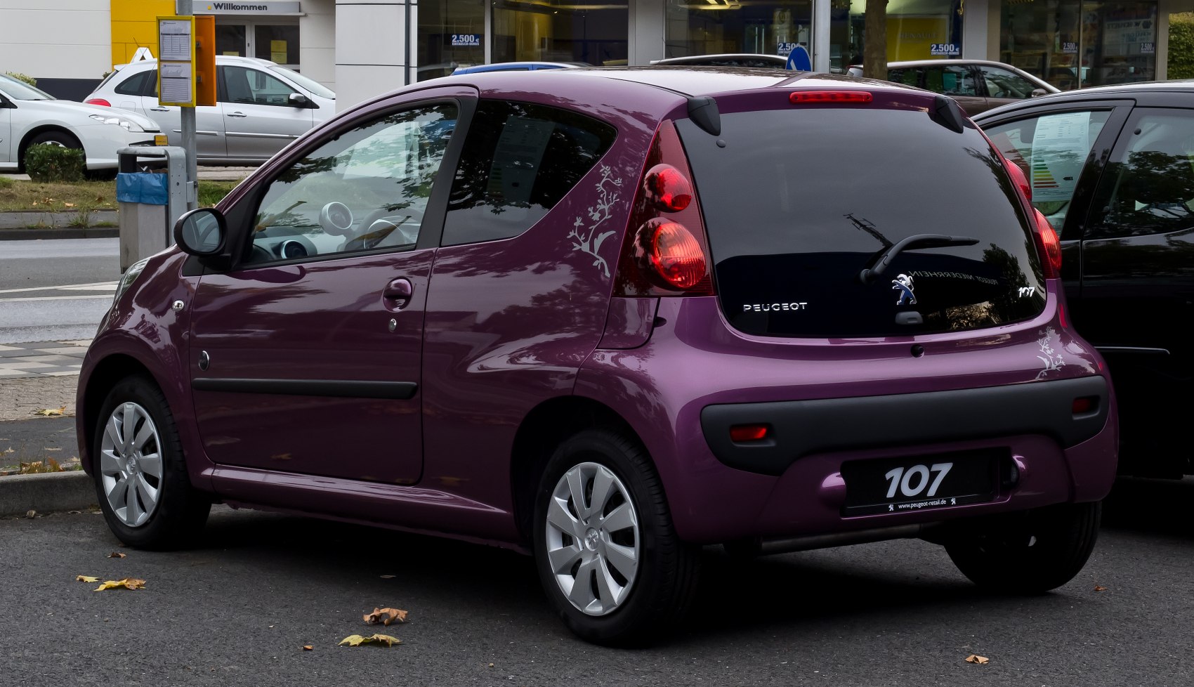 Rear view of compact 3-door hatchback with decorated quarter panel and distinct taillights