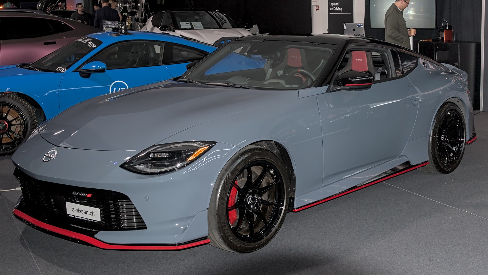 Front-side view of a sleek sports coupe with black rims and aerodynamic accents