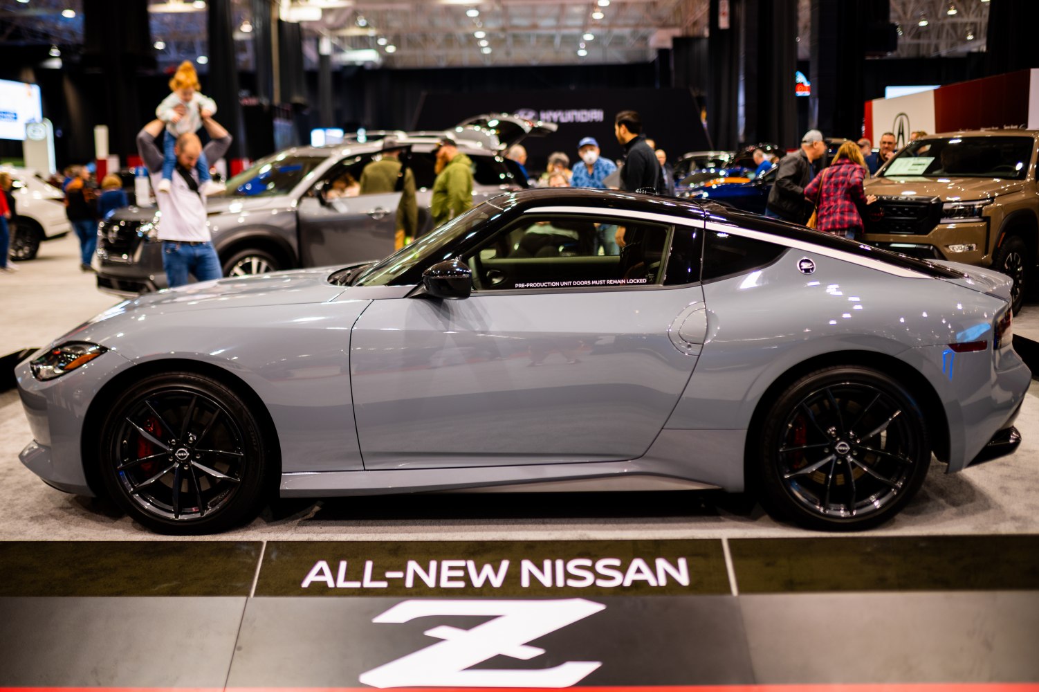 Side profile of a sleek sports coupe with black alloy wheels
