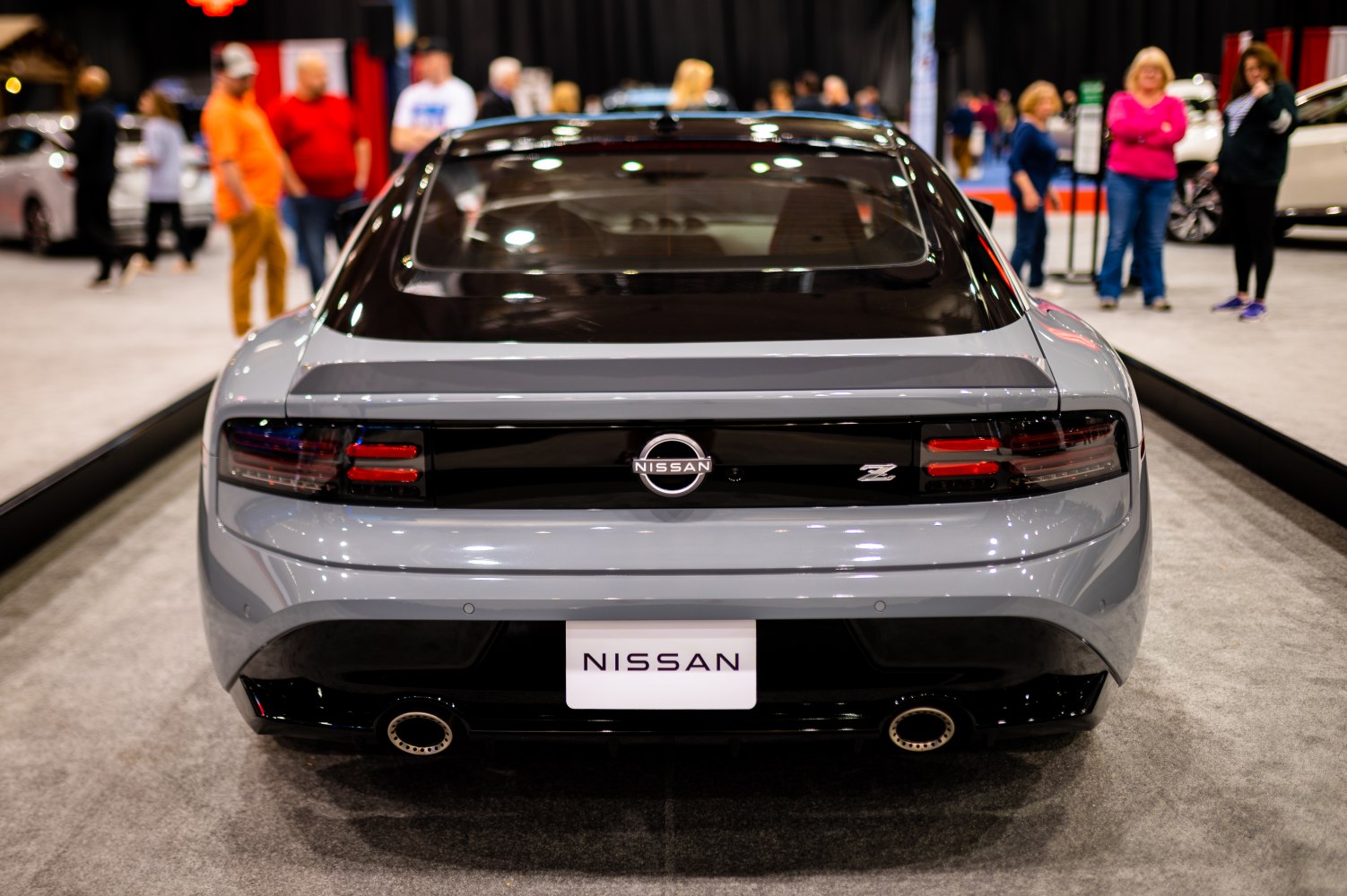 Rear view of a sporty coupe with distinctive tail lights and dual exhausts