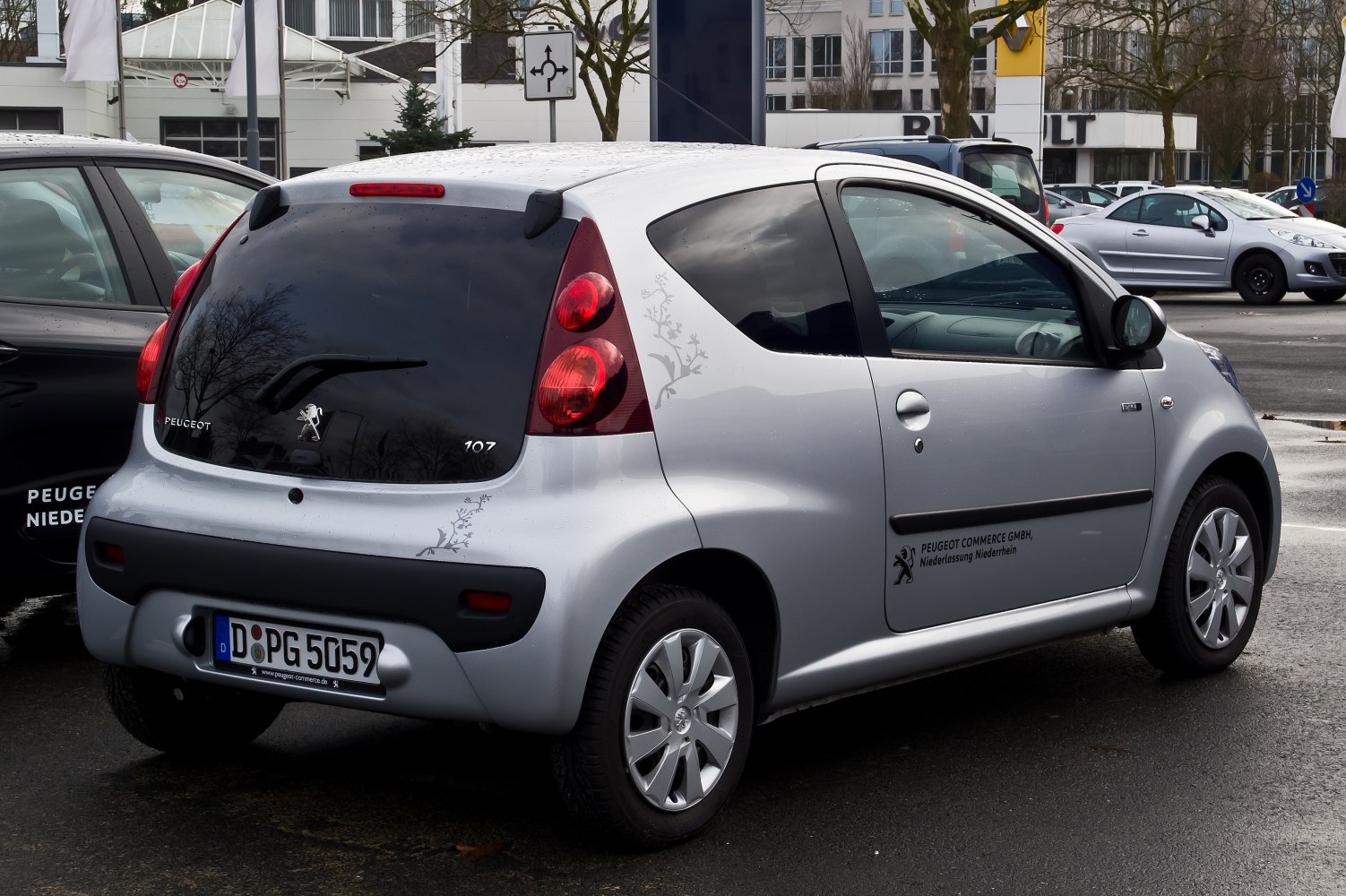 Compact hatchback rear window floral decal and vertical tail lights