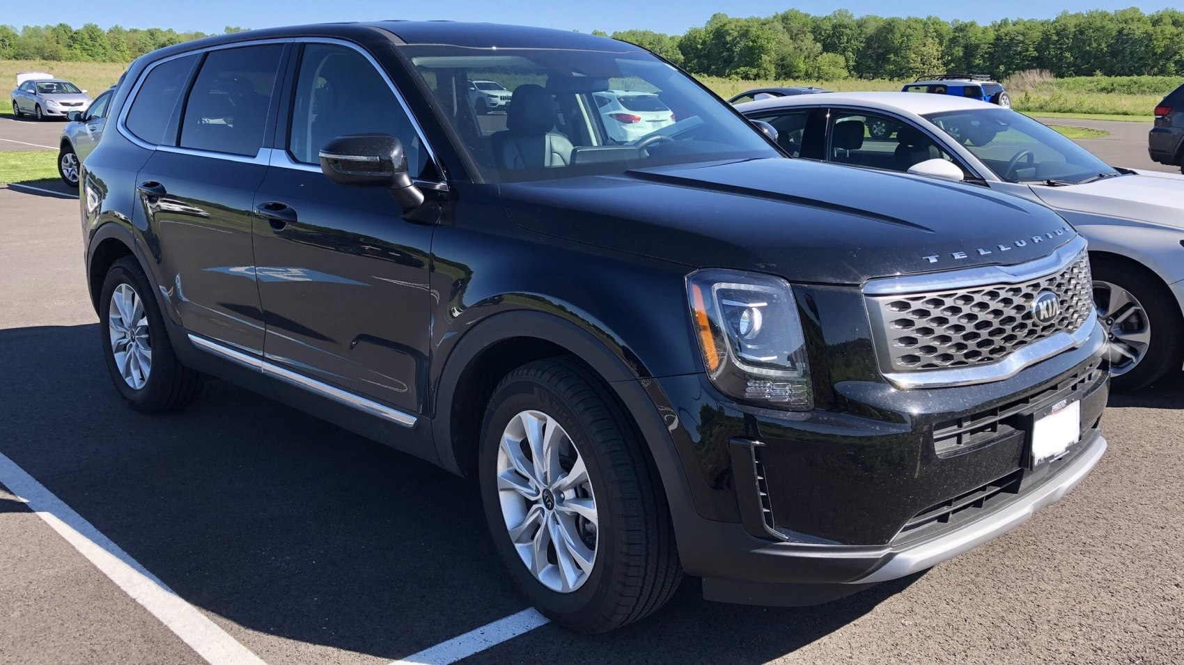 Front-side view of a black SUV with distinctive grille and headlights