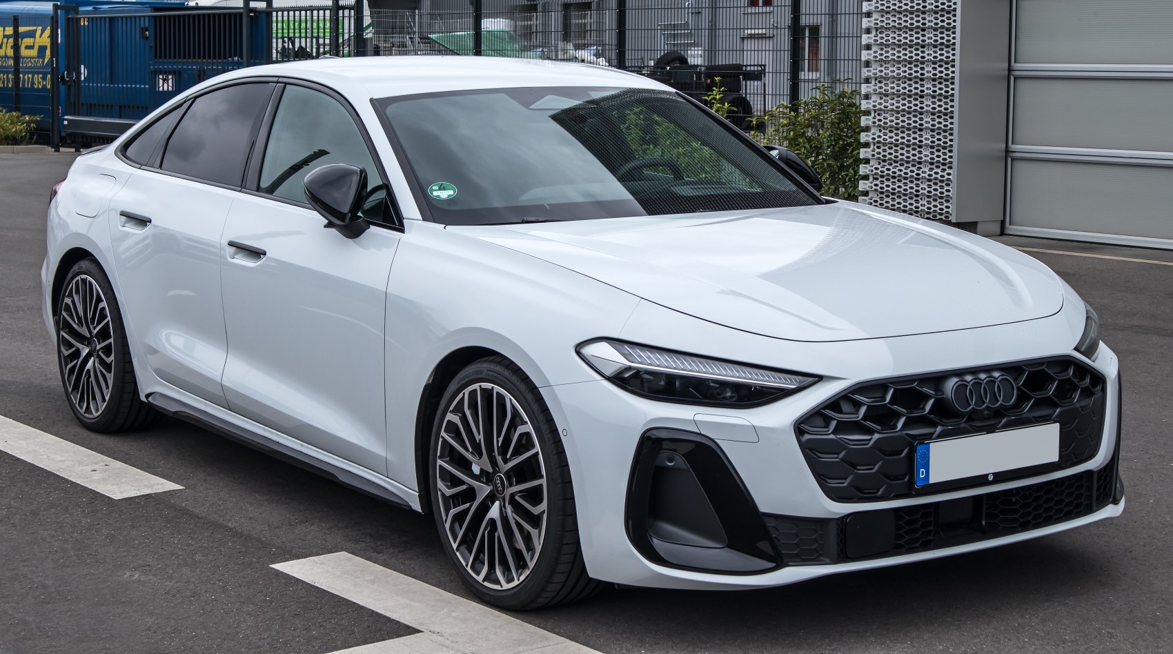 Modern sedan front profile with LED headlights and complex grille
