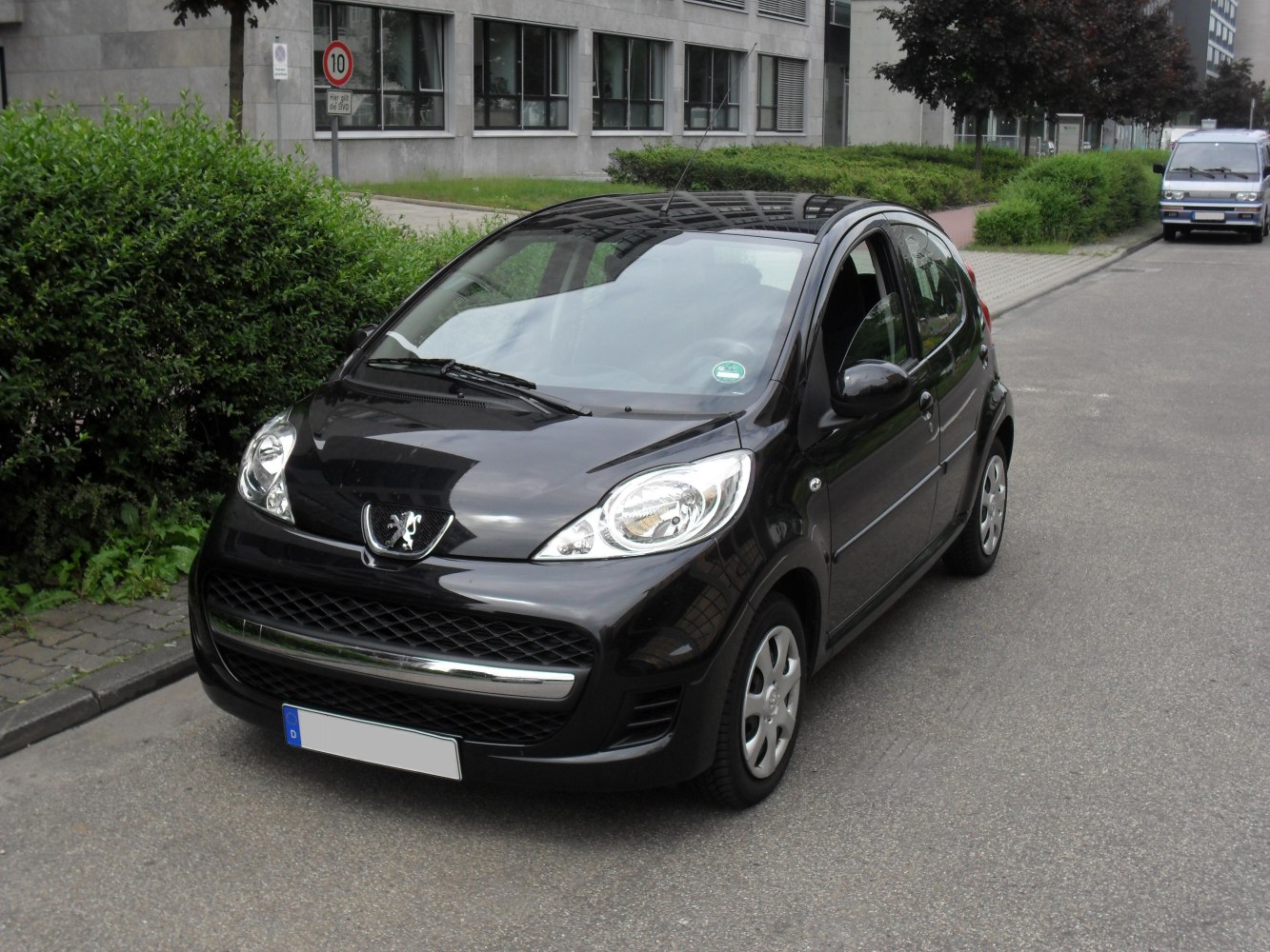 Compact black hatchback with rounded headlights and 5-door layout
