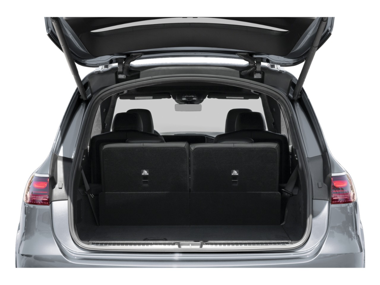 SUV rear cargo area with upright seats and open tailgate
