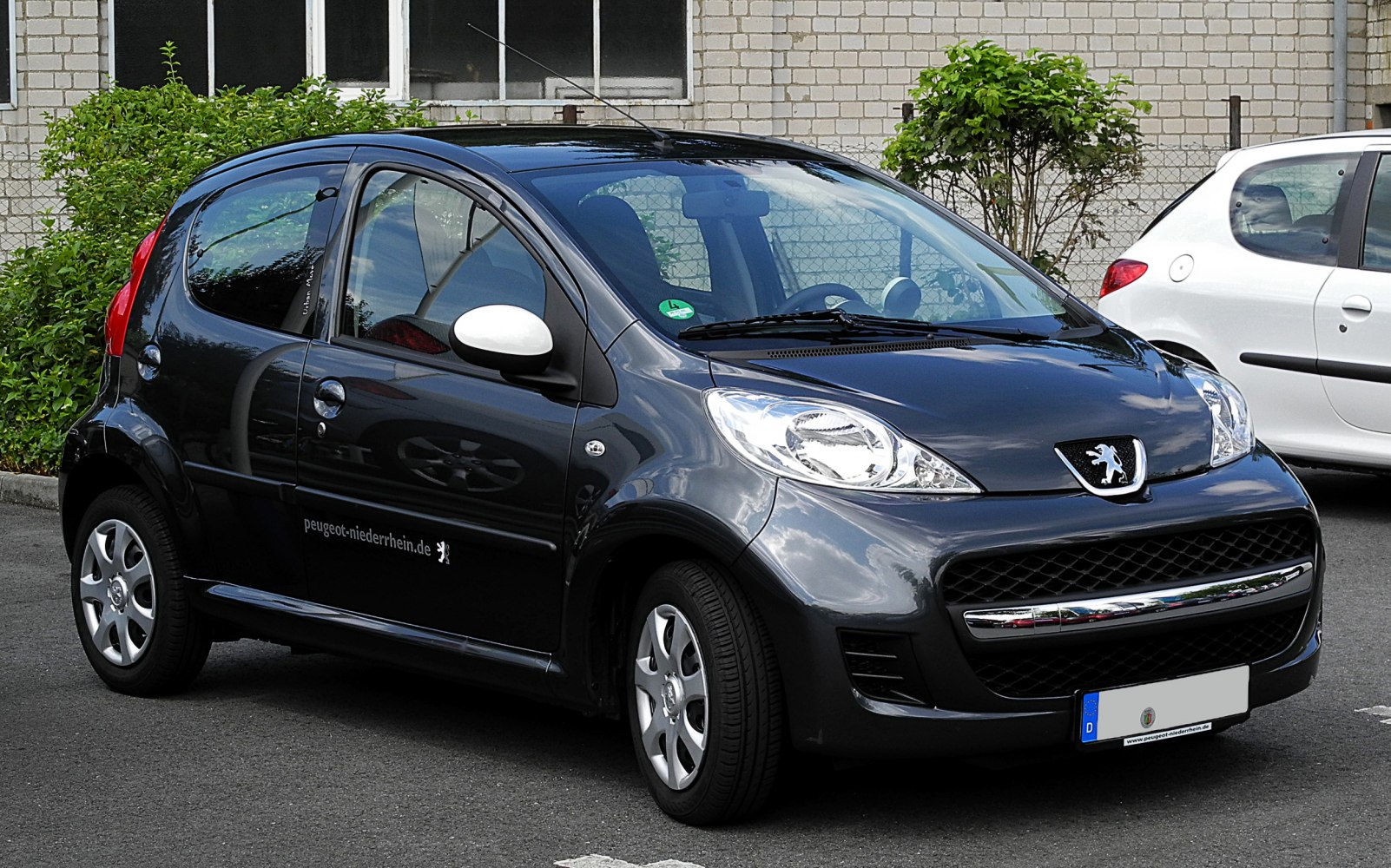 Compact black 5-door hatchback with distinctive front grille and headlights