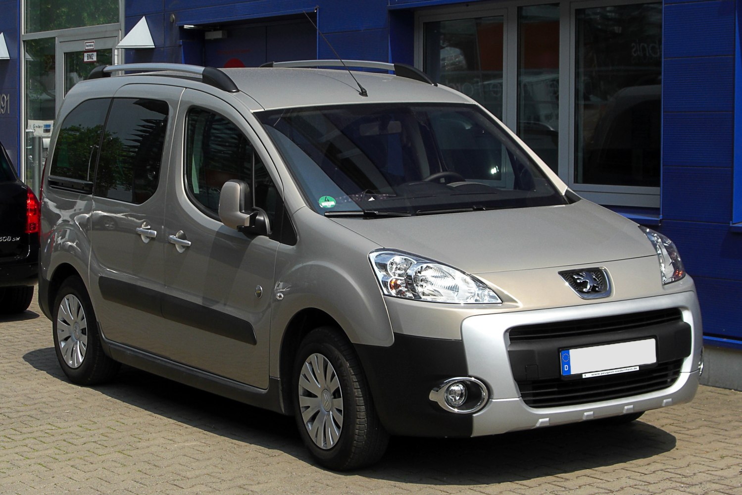 Compact MPV front view with roof rails and distinct headlights