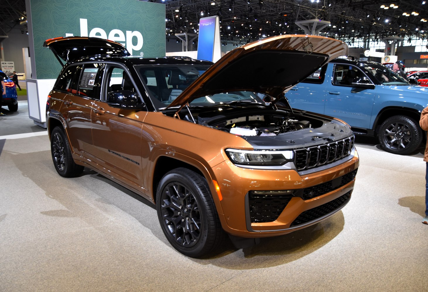 SUV with open hood and rear trunk at auto exhibition
