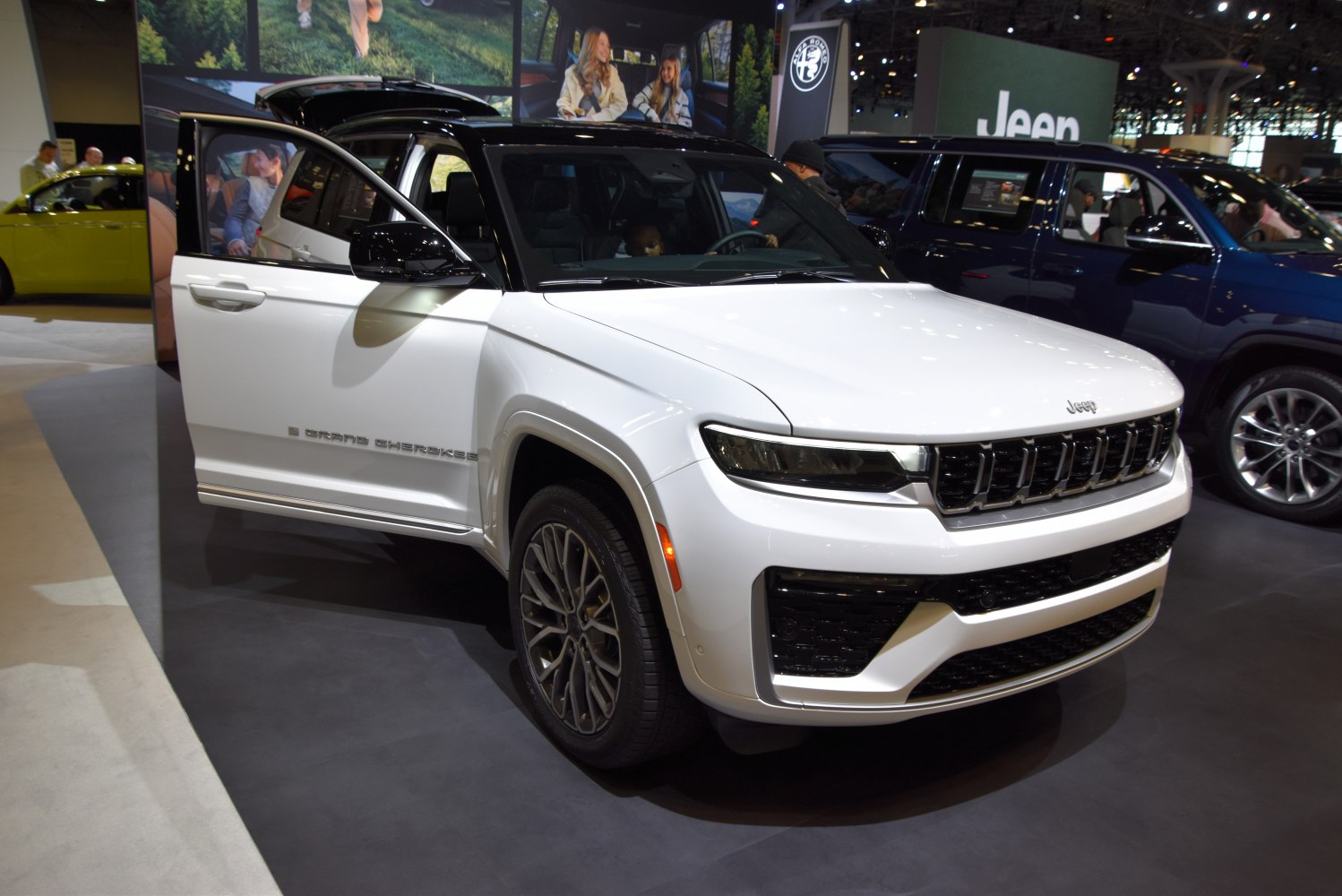 White modern SUV with bold grille and open door front view