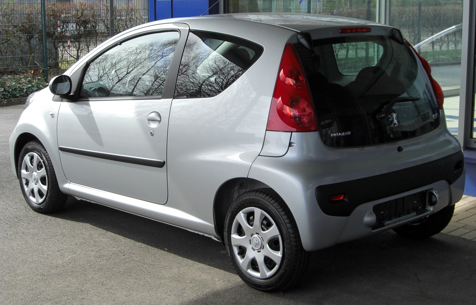 Rear side view of a small 3-door hatchback with distinctive taillights.