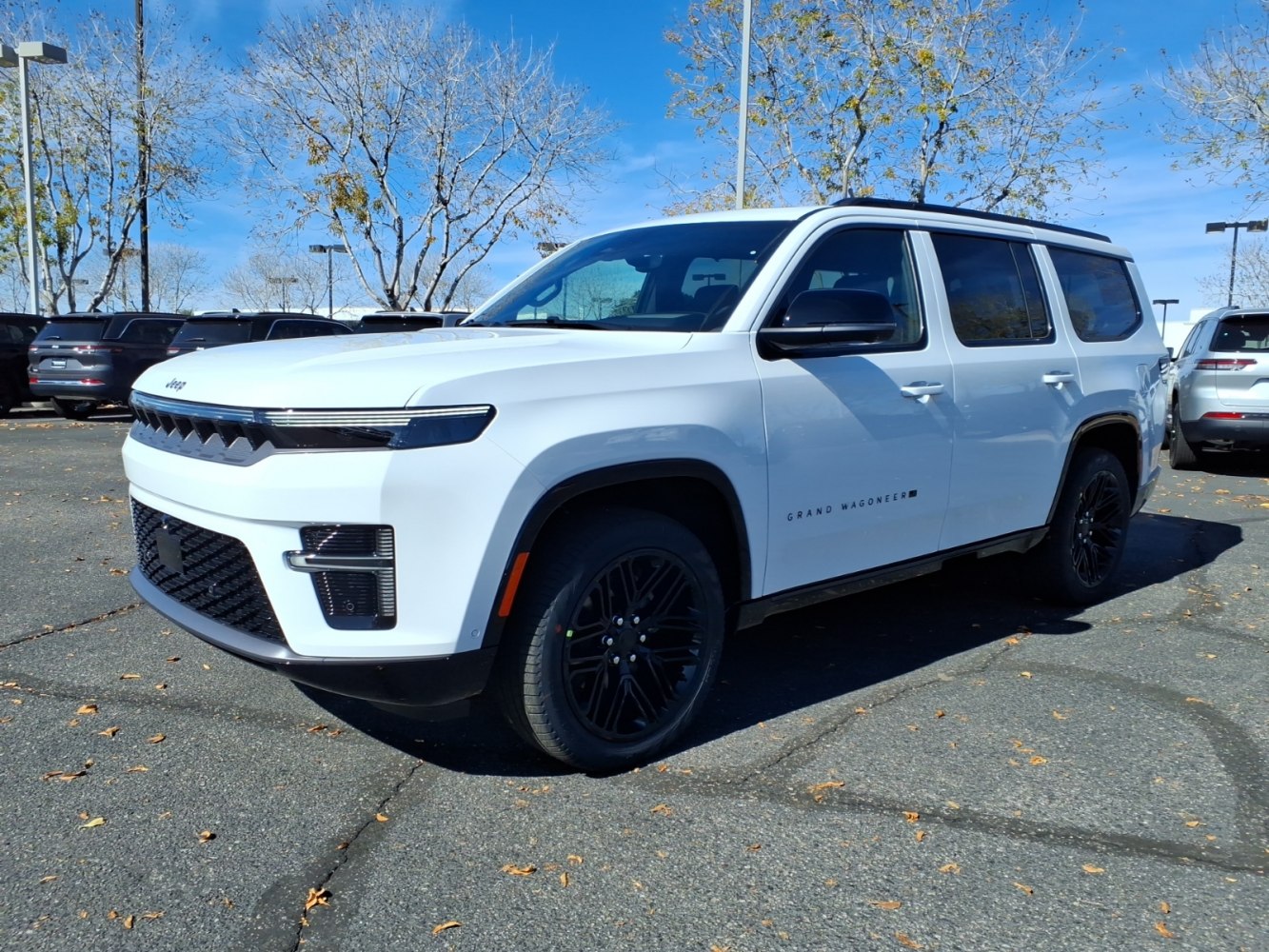 Full-size SUV front side showing bold grille and black wheels