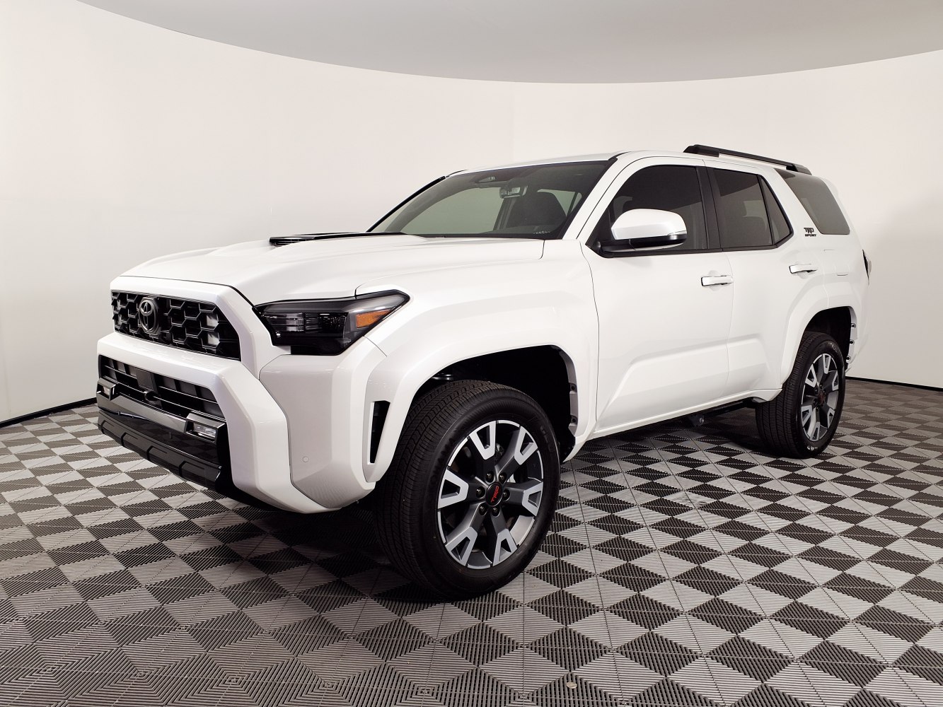 Bold front grille and multi-spoke alloy wheels on white SUV