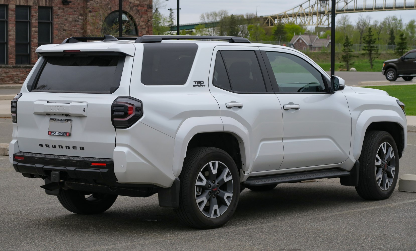 Rear and side view of an SUV with distinct taillights and roof rails
