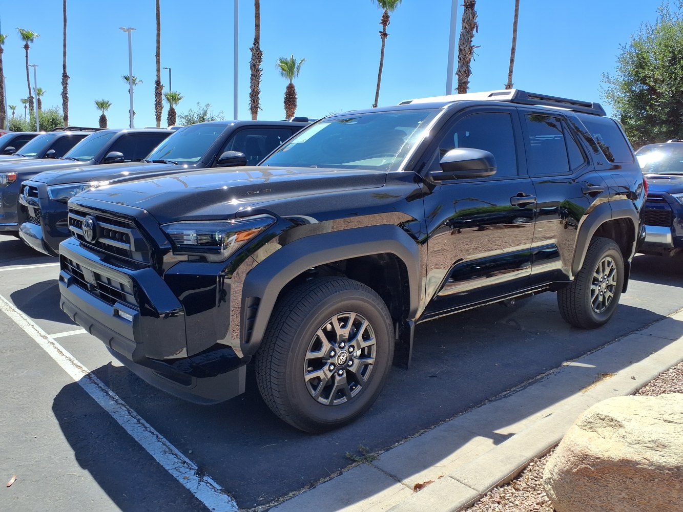 Black SUV front and side view with rugged design and modern headlights