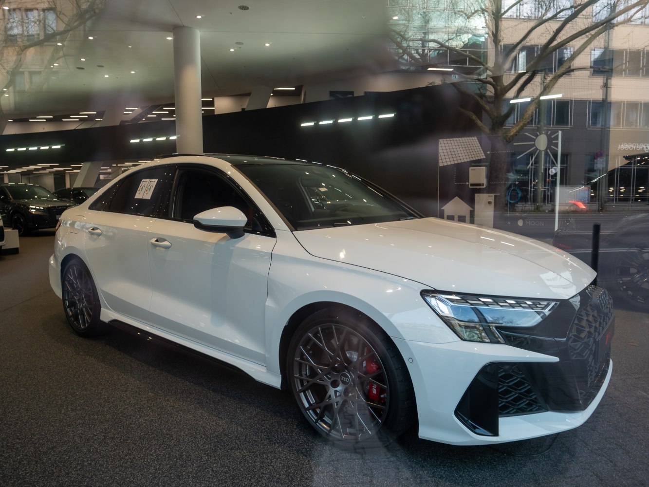 Facelift RS3 sedan front grille, headlights, and multi-spoke wheels with red brake calipers