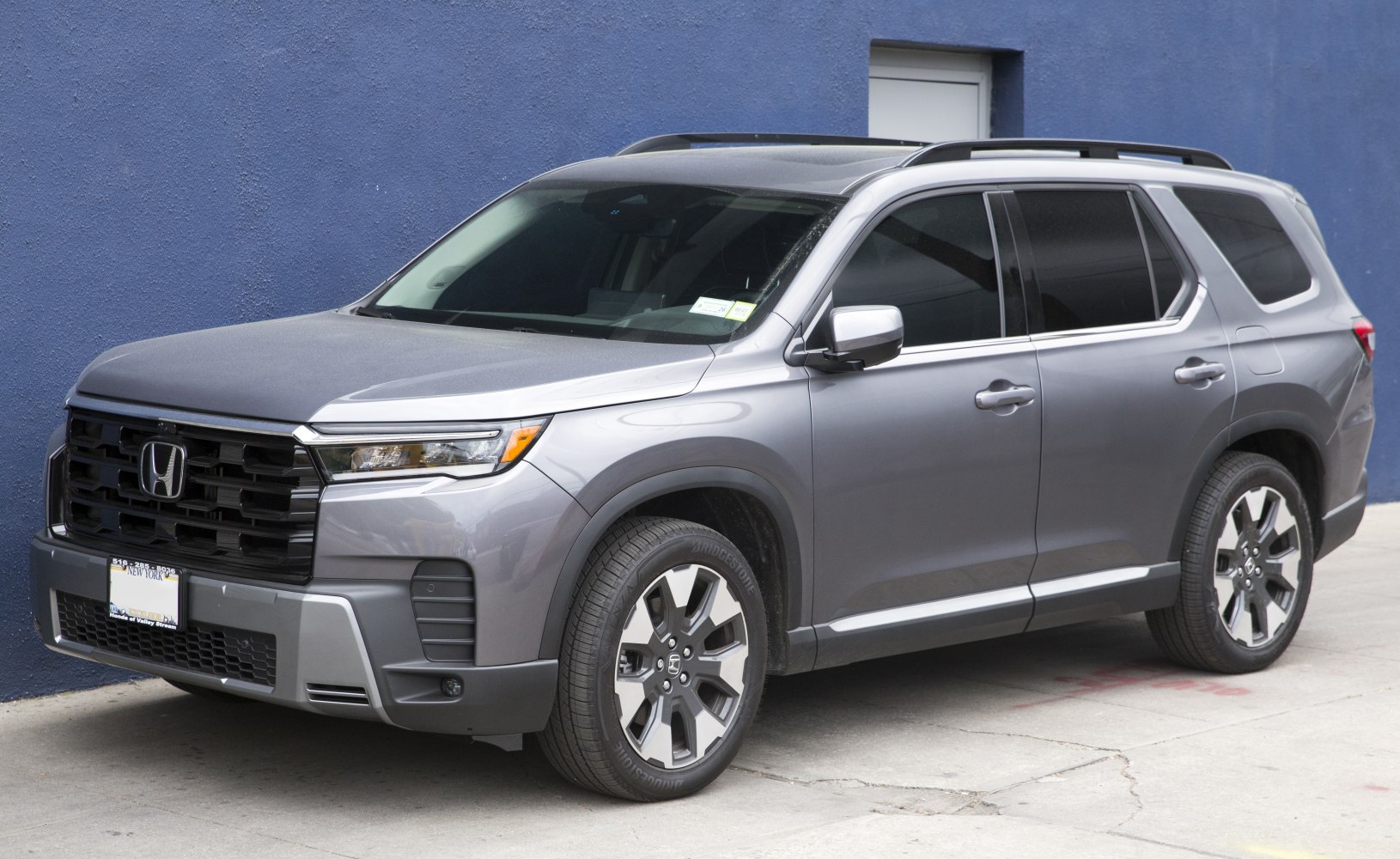 Front-side view of SUV with modern grille and alloy wheels