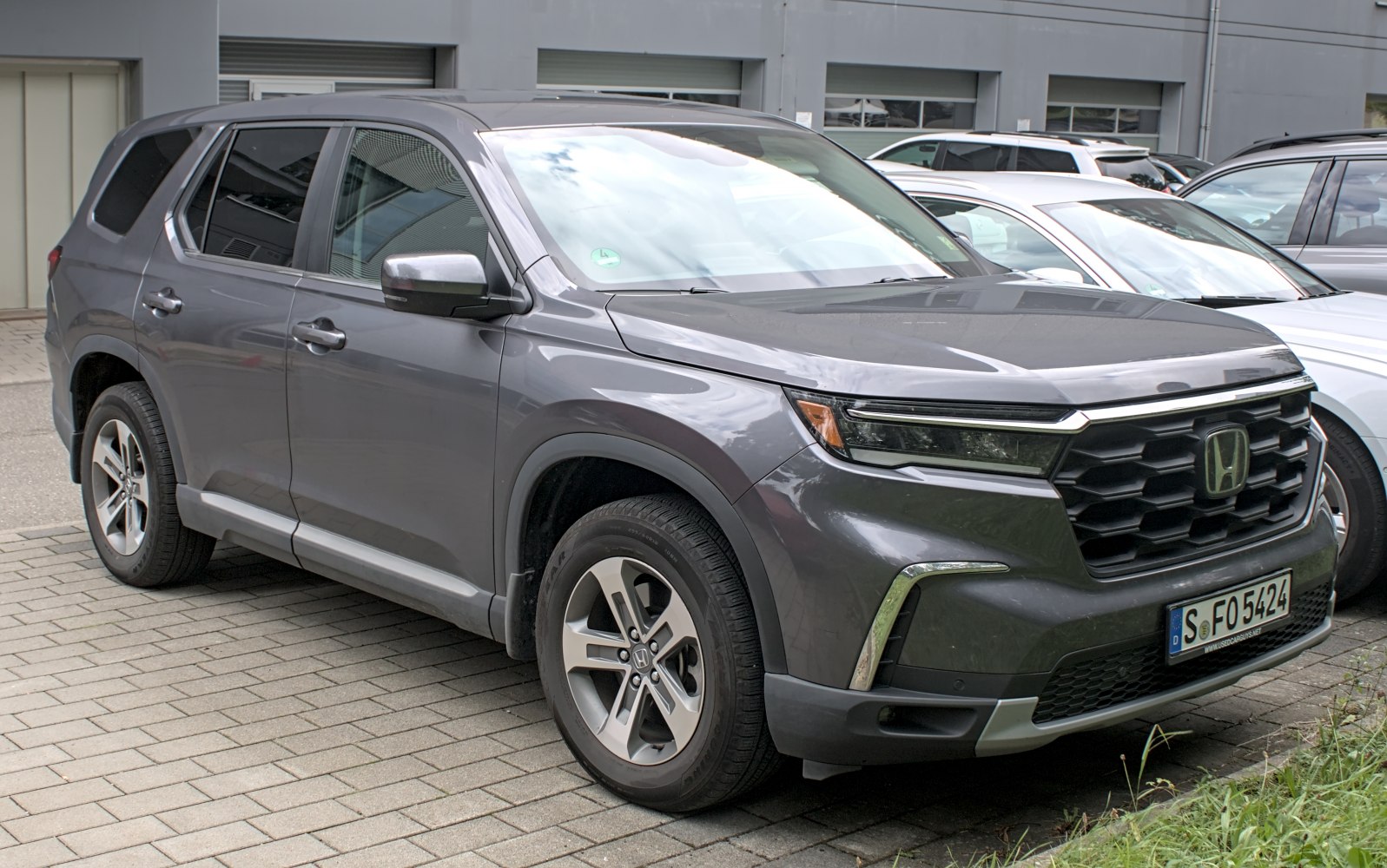 Front-side view of SUV with prominent grille and sleek headlights