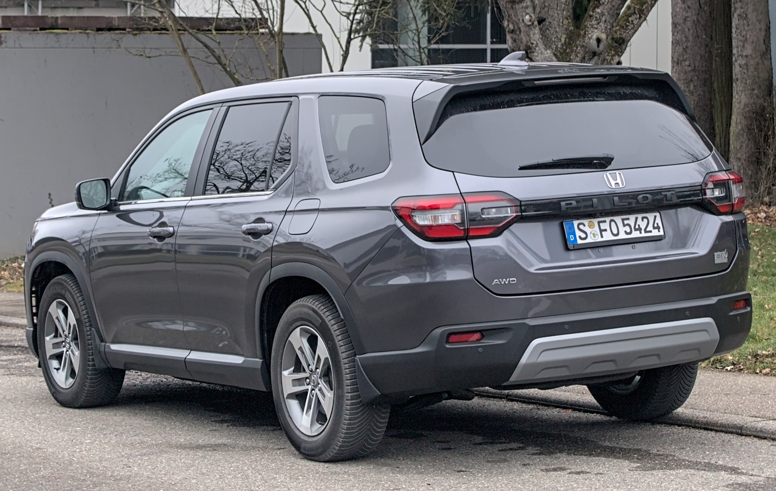 Rear-side view of modern SUV with tail lights and AWD badge