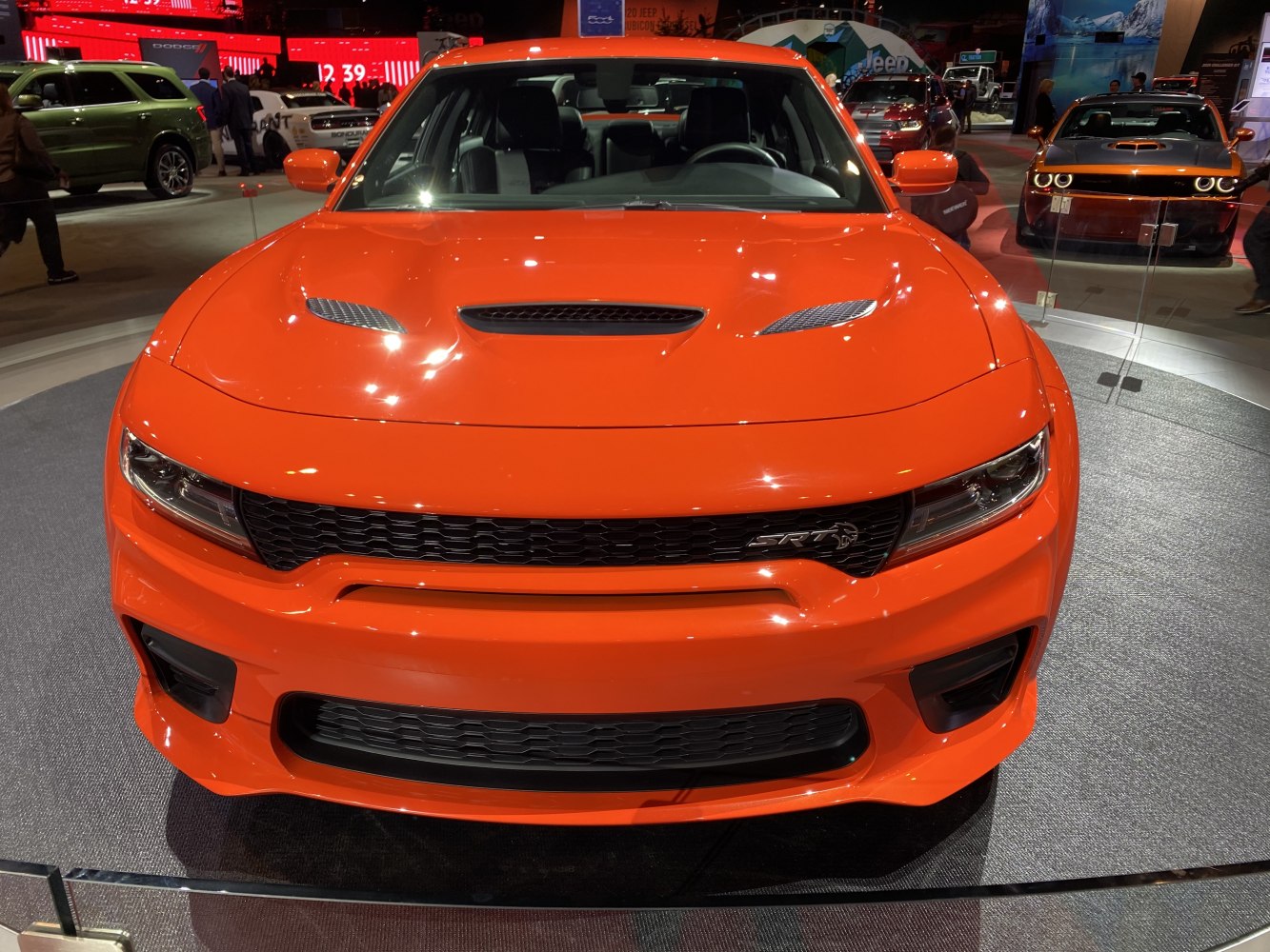 Aggressive front view with hood vents and sporty grille