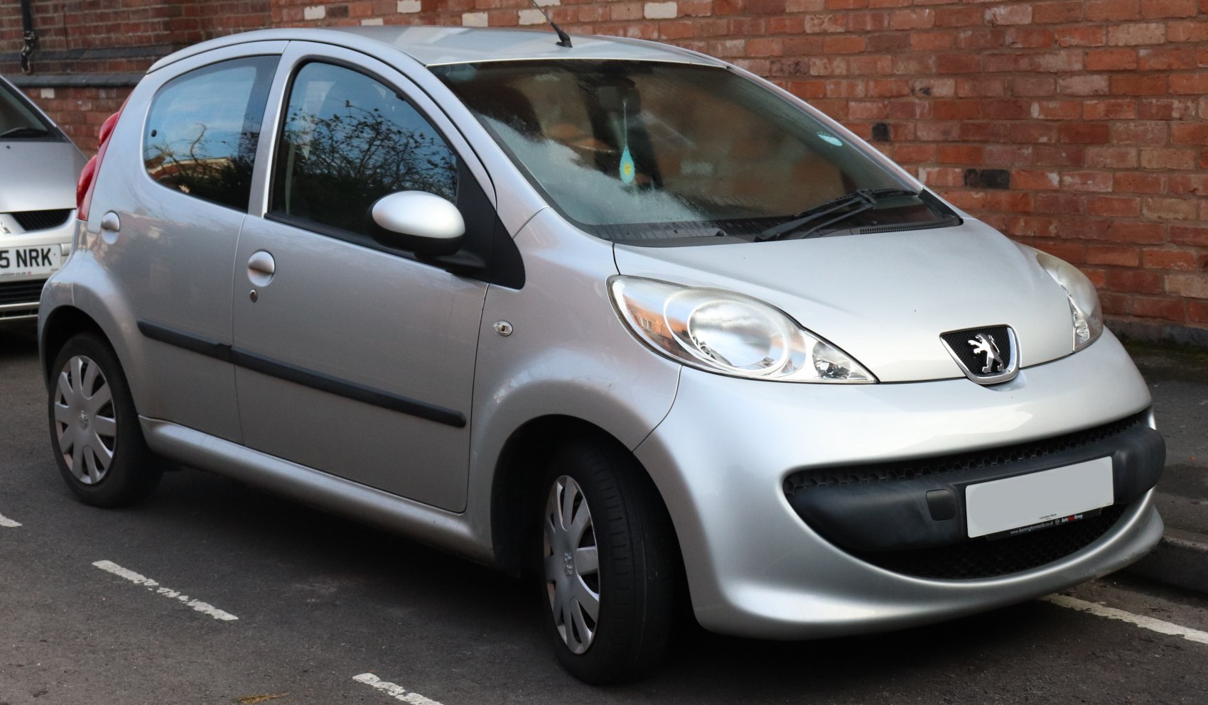 Compact silver 5-door hatchback with rounded headlights and smooth curves