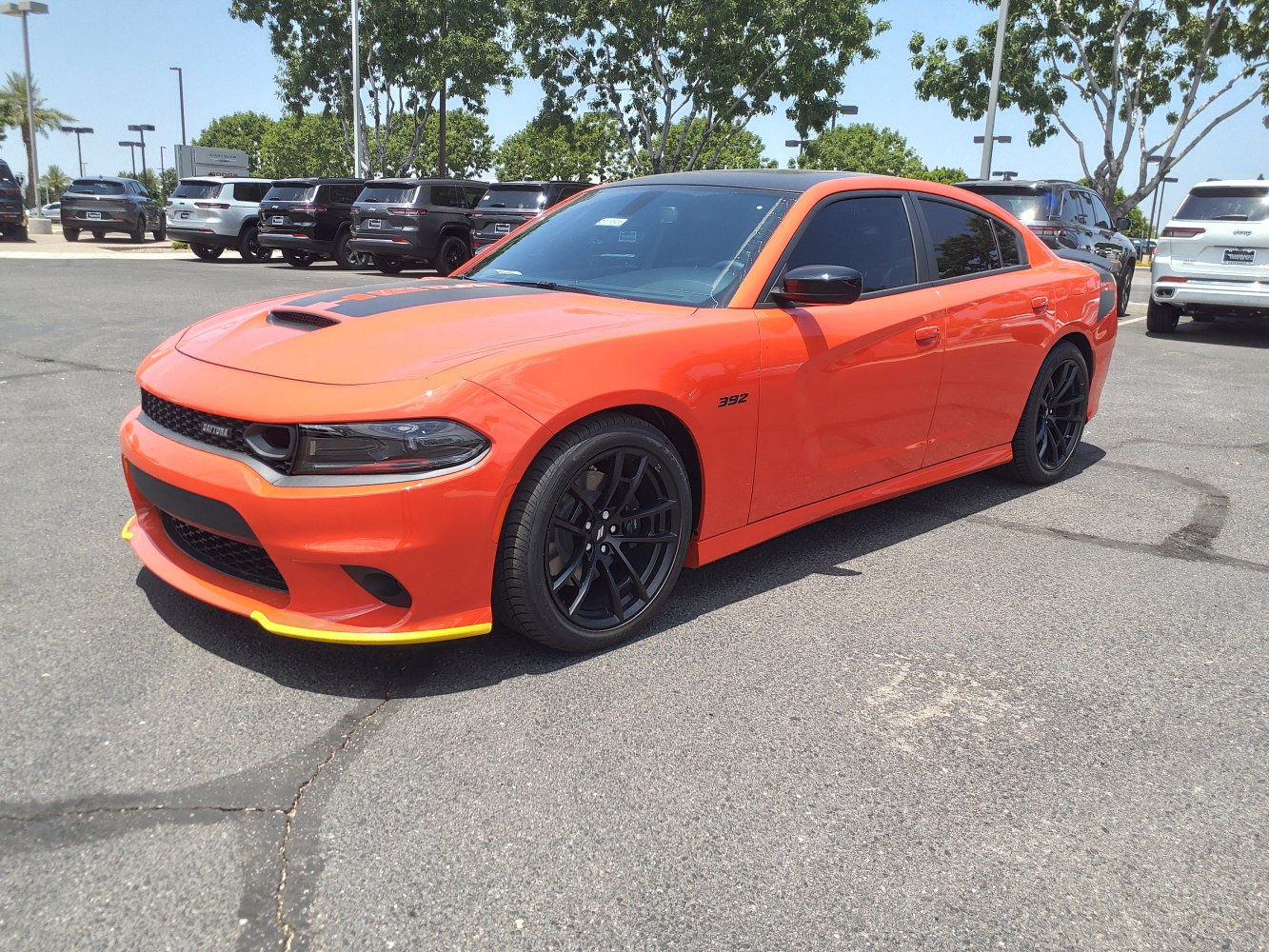 Bright sedan with hood scoop, black wheels, and front splitter accents