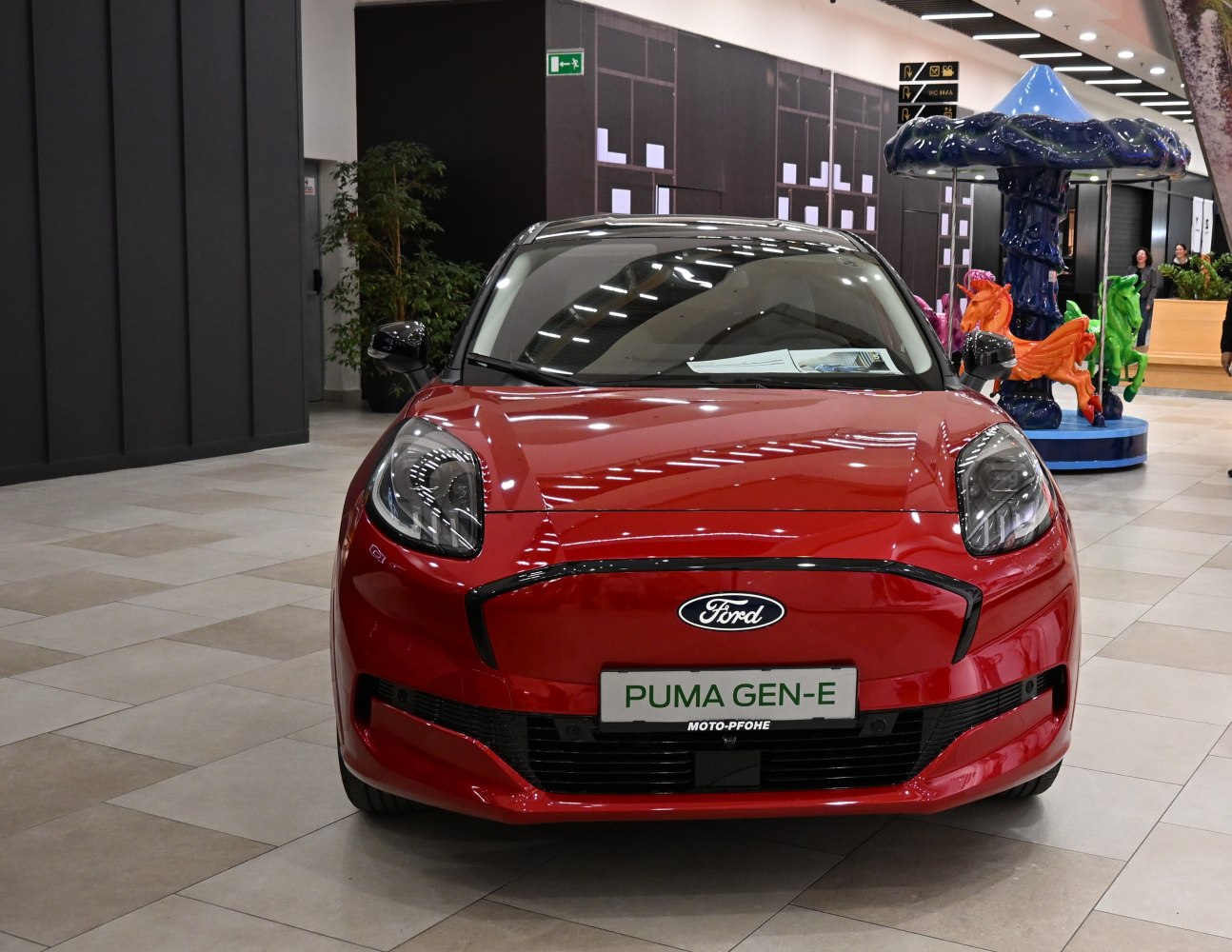 Front view of red 2024 Ford Puma facelift with distinctive headlights and grille