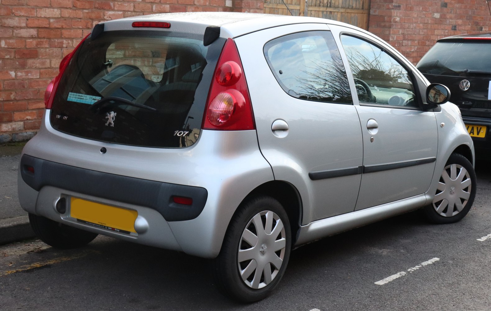 Rear and side view of a compact 5-door hatchback with distinctive taillights.