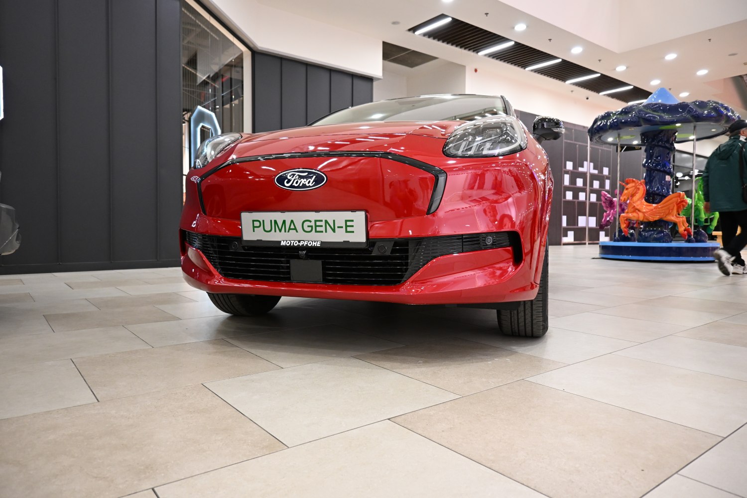 Front view of a compact electric hatchback with sleek bumper and LED headlights