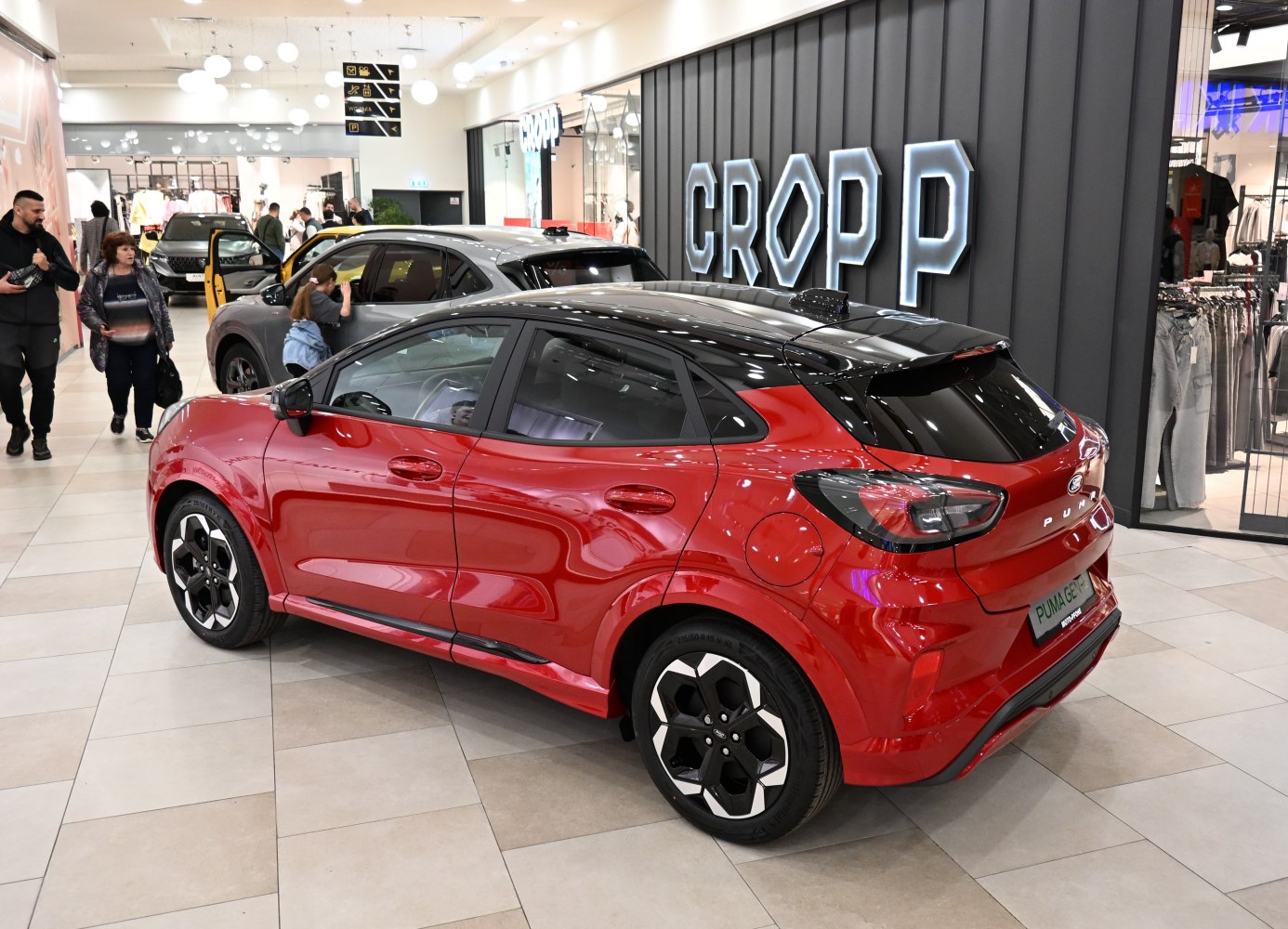 Red compact SUV with black roof and modern alloy wheels