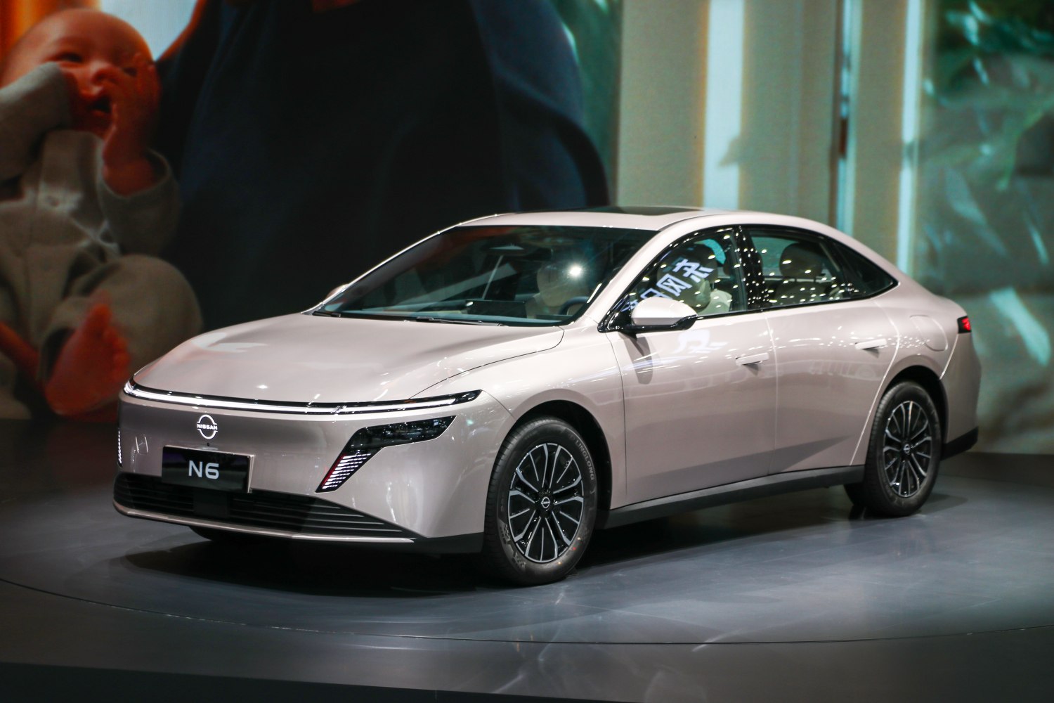 Sleek front side view of an electric sedan with LED headlights and streamlined design.