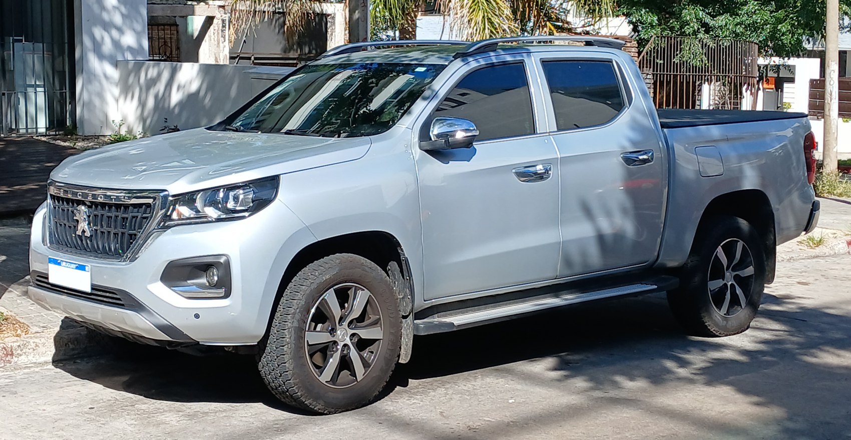 Double cab pickup with modern headlights and alloy wheels