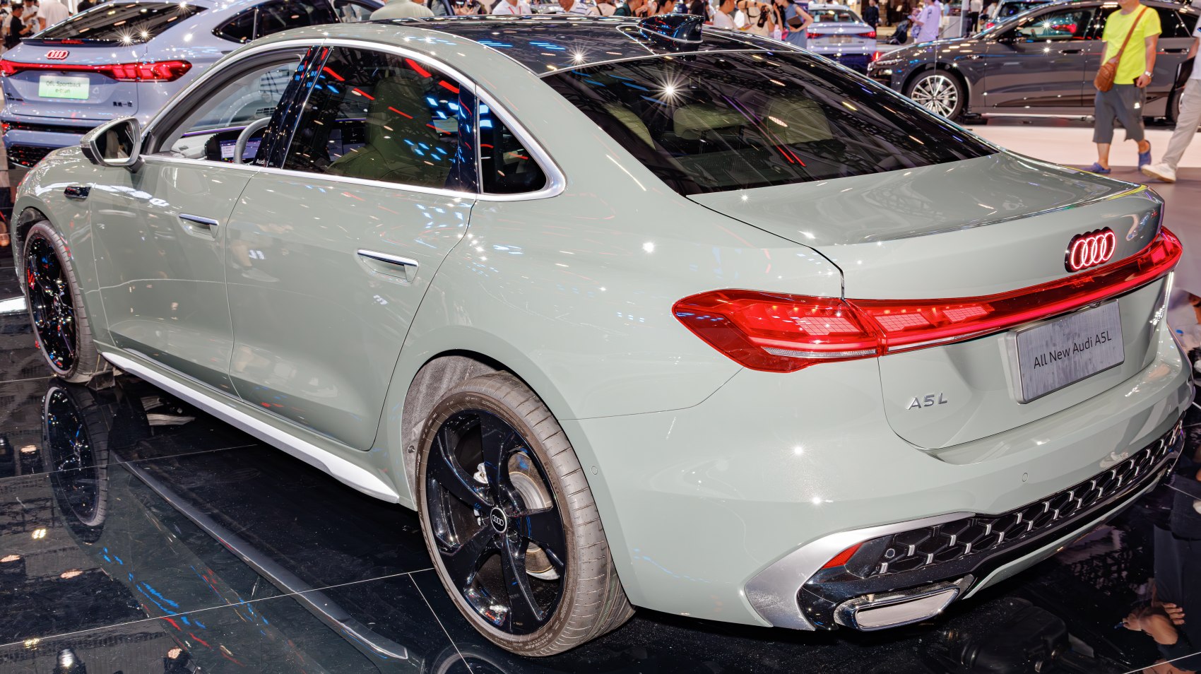 Rear and side view of a modern sedan with sleek tail lights and black alloy wheels