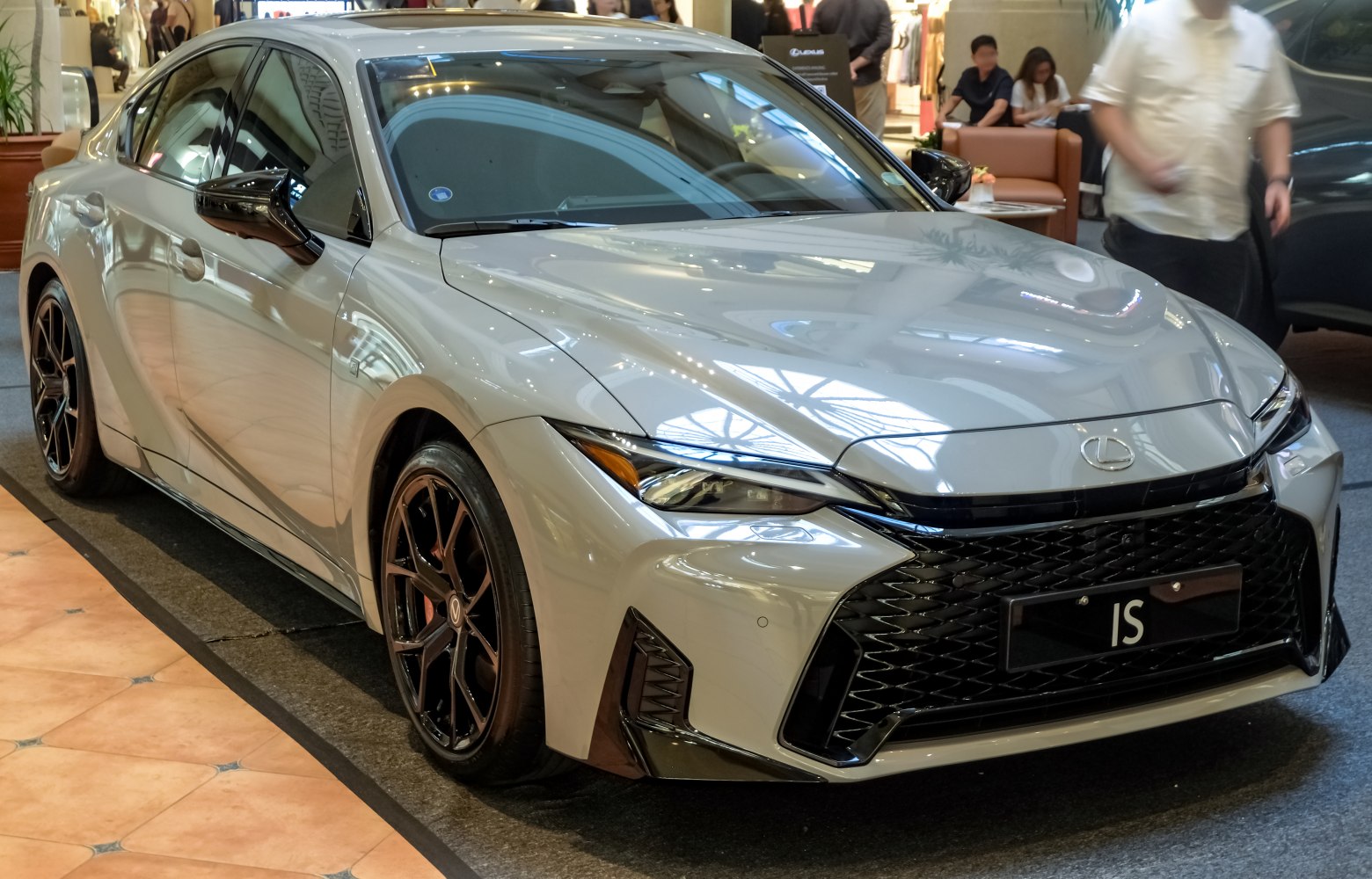 Aggressive front grille, sleek headlights, black multi-spoke alloy wheels