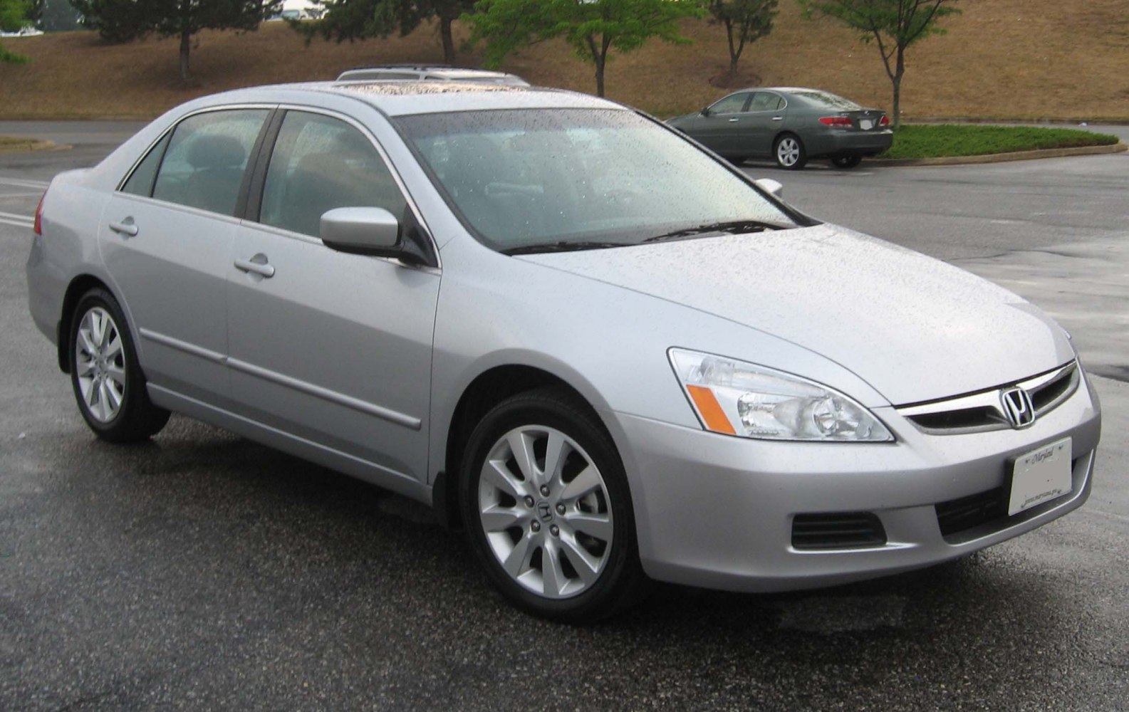 Silver midsize sedan with alloy wheels and clear front headlights