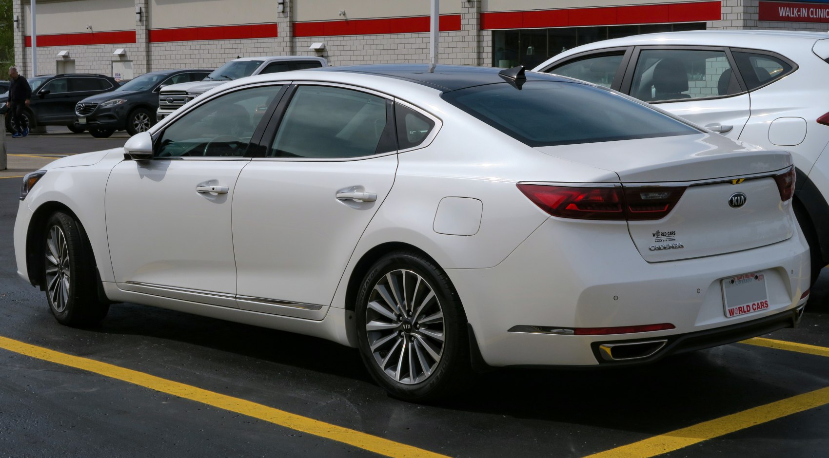 Rear side view of a white modern sedan with distinctive taillights and sleek design