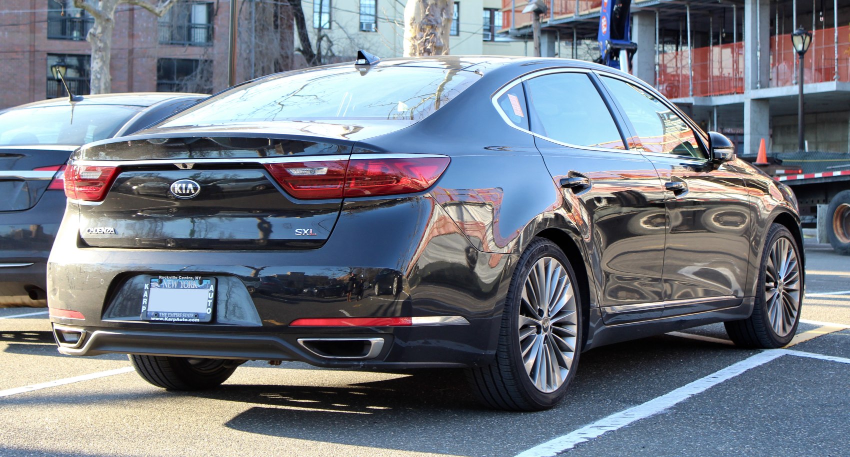 Rear view of sedan with dual exhausts and sleek taillights