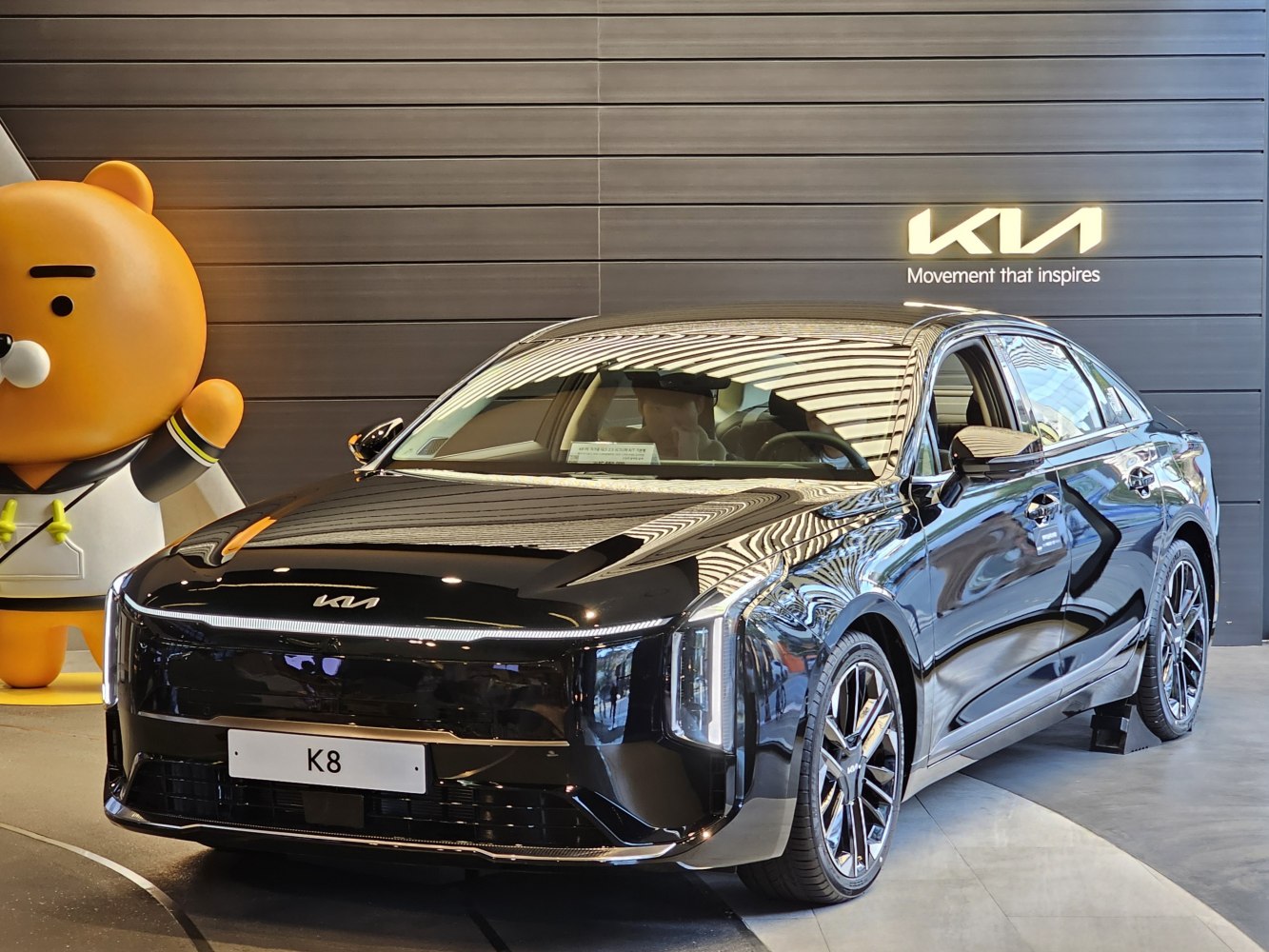 Gloss black sedan front with vertical LED headlights and aerodynamic design