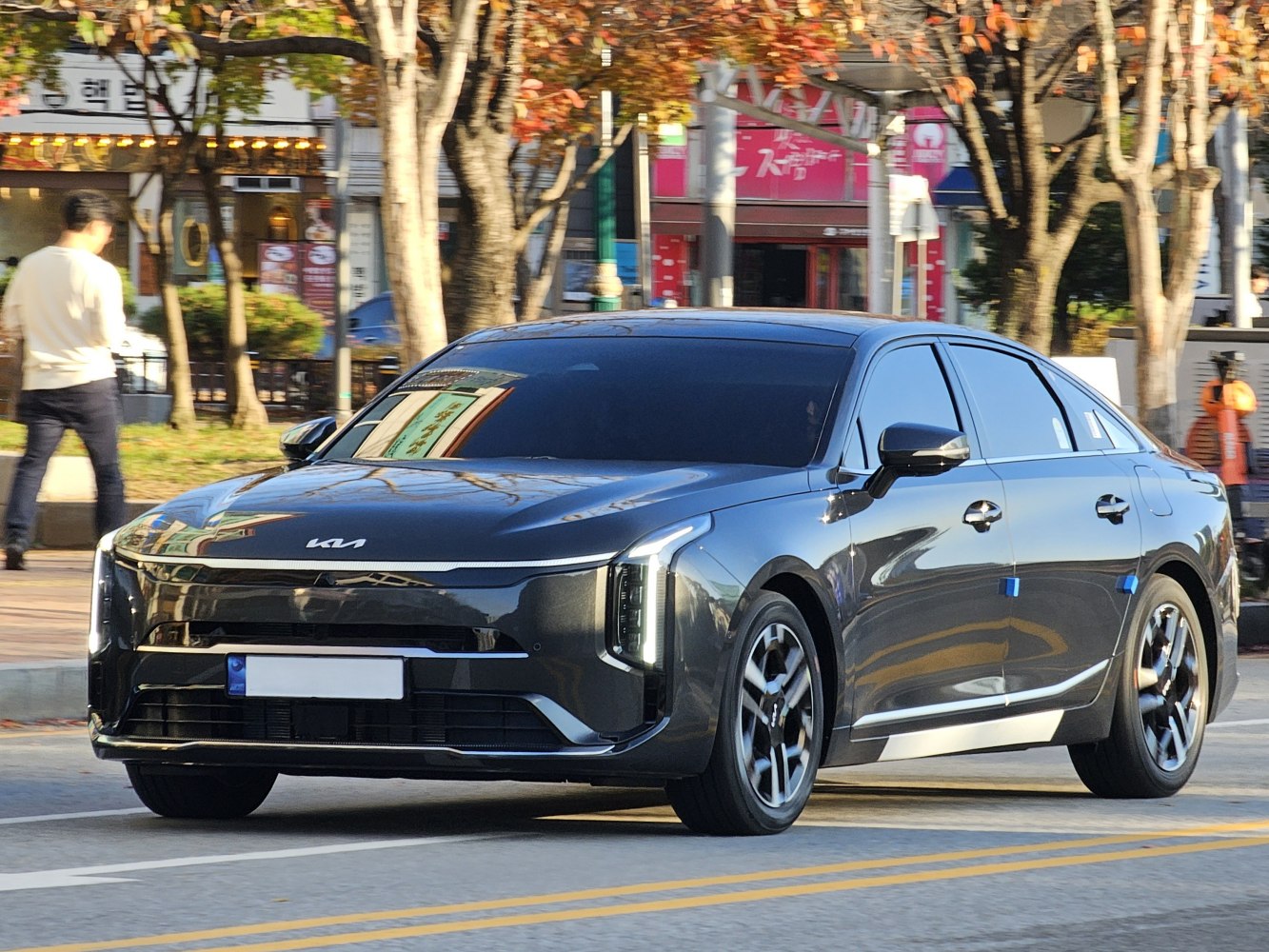 Modern luxury sedan with distinctive LED headlights and sleek front design