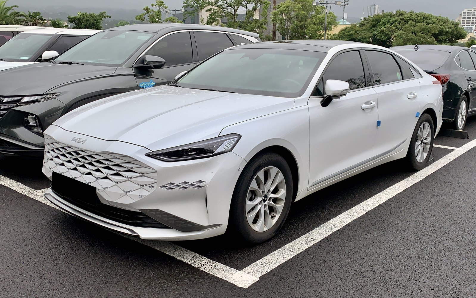 White sedan with diamond grille and sleek headlights